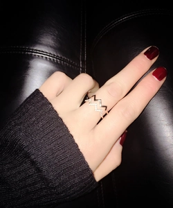 Detail of a double-layer rose gold zigzag ring featuring micro-pave white zircon stones