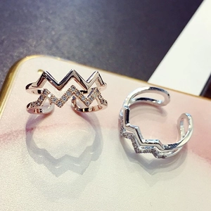 Detail of adjustable double-layer wave rings with micro-set zircons in rose gold and silver