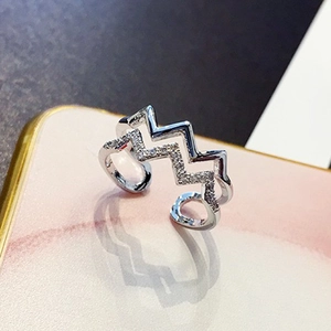 Detail of silver double-layer wave ring with polished finish and micro-inlaid zircons
