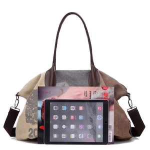 Canvas tote bag with brown leather handles and adjustable strap showing storage capacity