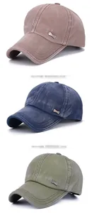 Close-up of classic metal tags on washed cotton baseball caps in khaki, blue, and green