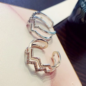 Close-up of minimalist double-layer zigzag rings with sparkling zircon crystals