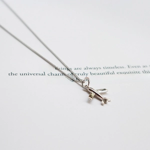 Macro shot of 925 sterling silver airplane pendant with polished finish and O-chain detail