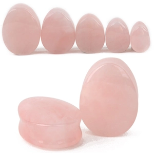 Gros plan sur les écarteurs goutte en quartz rose poli montrant la texture naturelle
