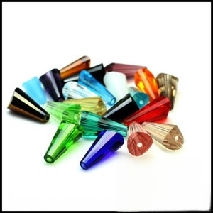 Close-up of assorted colorful faceted fish-shaped crystal beads for DIY jewelry making
