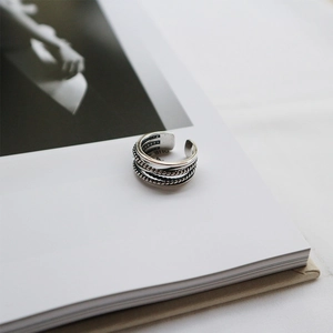 Macro detail of triple-layered S925 sterling silver twist ring with vintage finish