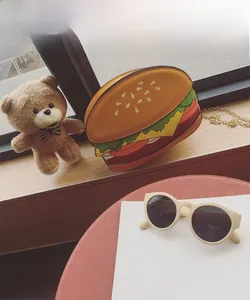Detailed view of novelty hamburger crossbody bag with layered design and gold chain strap