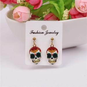 Detail shot of colorful Day of the Dead skull earrings on a fashion jewelry display card