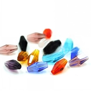 Close-up of diamond shaped multi-faceted crystal glass beads in assorted gradient colors
