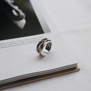 Macro view of vintage silver S925 ring with layered rope and beaded texture details
