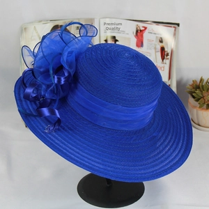 Detailed close-up of navy blue organza mesh hat with 3D floral accent and ribbon