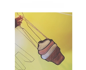 Detailed view of ice cream shaped crossbody bag with quilted cone texture and gold chain