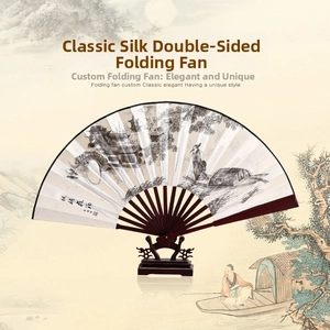Detail of silk folding fan with traditional landscape painting on black wooden stand