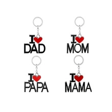 Detail view of four puzzle keychains with I Heart Mom, Dad, Papa, and Mama metal charms