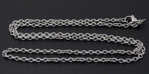 Detail of silver stainless steel cable chain with a lobster clasp on black background