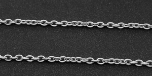 Macro view of polished silver stainless steel O-chain links on a black background