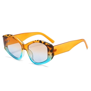 Polygonal oversized sunglasses with orange frames and gradient lenses on white background