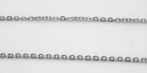 Detailed close-up of polished silver stainless steel hammer cross chain necklaces on white