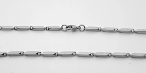Macro detail of silver stainless steel rectangular link chain with a secure lobster clasp