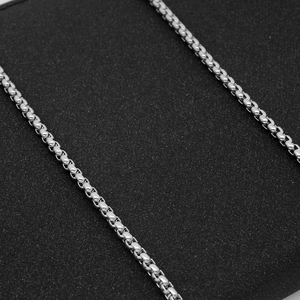 Polished silver stainless steel chain necklace with interlocking links shown in close-up