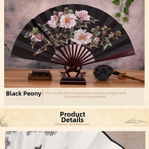 Detail of black silk folding fan featuring painted pink peonies on a wooden stand