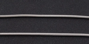 Macro shot of two polished stainless steel round snake chains on a black background