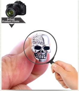 Macro shot of silver skull stud earring with detailed crystal zircon pave setting