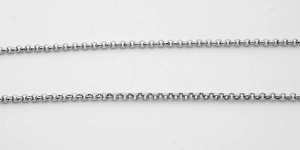 Macro detail of 3mm silver stainless steel round pearl link chain with metallic texture