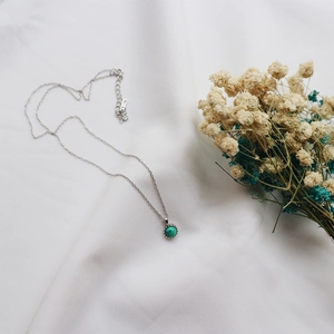 Macro detail of S925 sterling silver stamp on minimalist turquoise pendant necklace