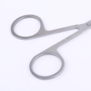 Polished stainless steel beauty scissors with ergonomic ring handles and material stamp