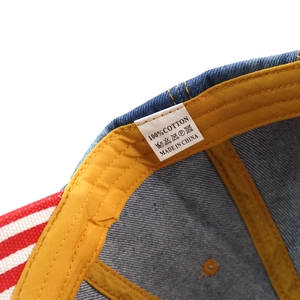 Detail of 100% cotton label and stitching inside the striped denim baseball cap