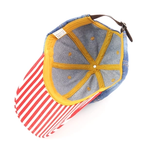 Detailed view showing the striped brim and soft cotton lining of this denim baseball cap