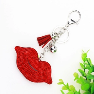 Detail of red rhinestone lip keychain with leather tassel and silver metal ring