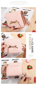 Detail of pink leather wallet featuring golden cat ear metal deco and tassel zipper