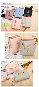 Detail of cute cat ear metal clasp and leather tassel on a stylish women's wallet