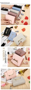 Detail of colorful women's wallets with cat-ear metal buckles and long fringe zippers