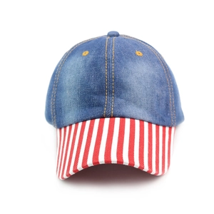 Detail of blue denim baseball cap with red and white striped visor in retro sports style