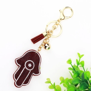 Detailed wine red Hamsa Hand keychain with gold tassel, bell and white beaded edge