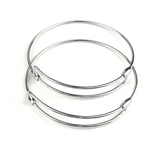 Detail of silver layered hollow circle bracelets with adjustable slide clasp on white background