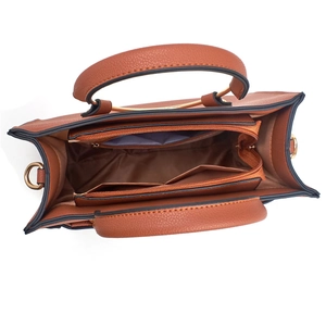 Internal view of brown tote bag showing dual zipper compartments and pebbled texture