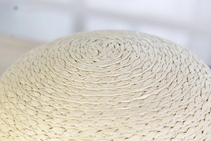 Macro shot of the beige woven straw hat crown showing detailed spiral texture