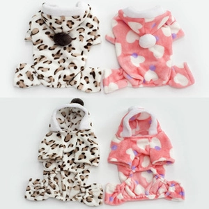 Detail of leopard print and pink heart flannel pet onesies with plush pom-poms on the hood