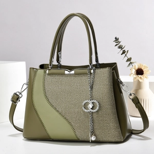 Olive green mini shoulder bag with woven texture, metal trim, and pearl charm detail