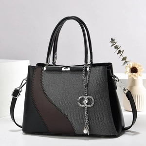 Chic patchwork crossbody phone bag in black and brown leather with silver chain accent