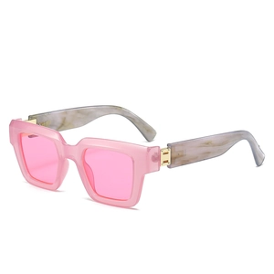 Square pink resin sunglasses with grey marble textured temples and gold metal hinges