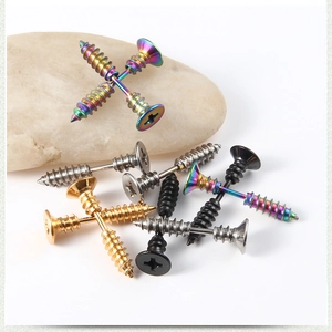 Macro shot of industrial screw-shaped stud earrings in steel, gold, black and rainbow