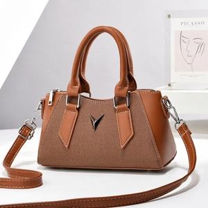 Brown mini crossbody phone bag with silver V-shaped buckle and adjustable shoulder strap