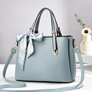 Light blue faux leather mini tote bag with ribbon detail and fashion lettering