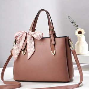 Chic dusty pink pebbled leather crossbody bag with top handles and checkered scarf detail