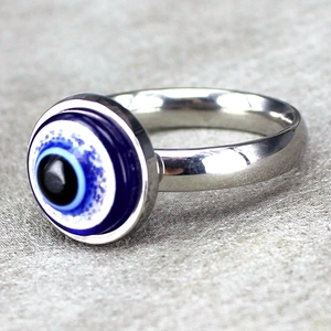 Polished stainless steel ring featuring a blue evil eye motif in a minimalist silver band